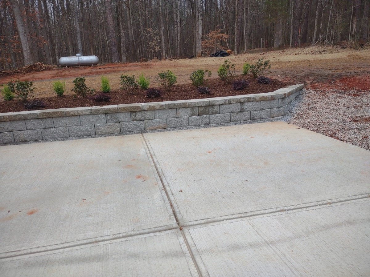 New retaining wall with fresh shrub plantings